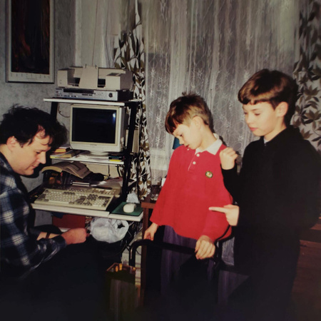 Retro photo where brothers playing chess with father